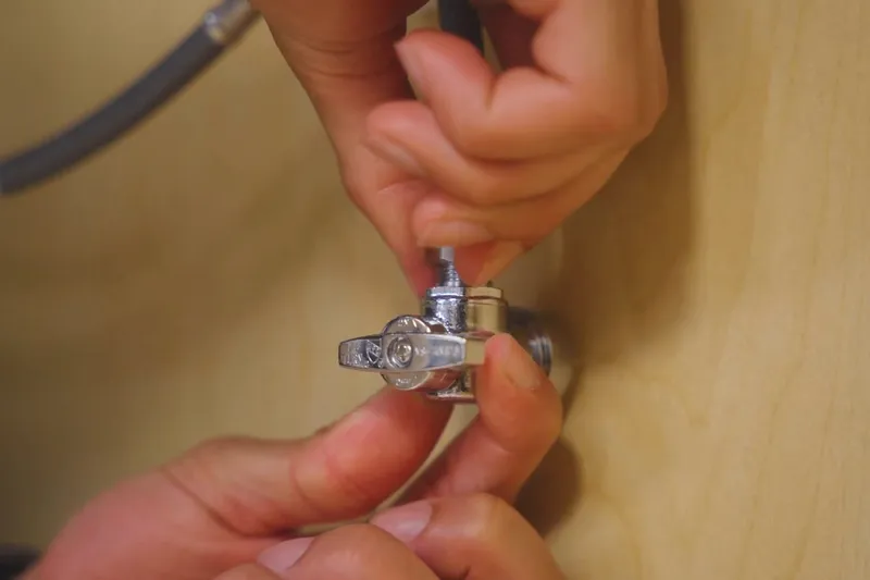 Sink faucet and under-sink drain connection being serviced for A faucet left to drip
