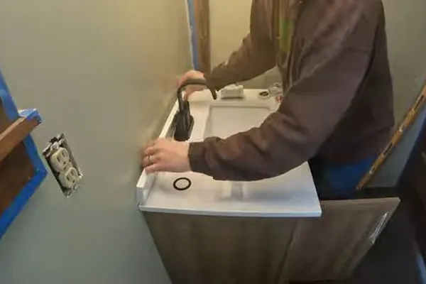 Sink faucet and under-sink drain connection being serviced for Scale on an aerator in Prescott Valley, AZ