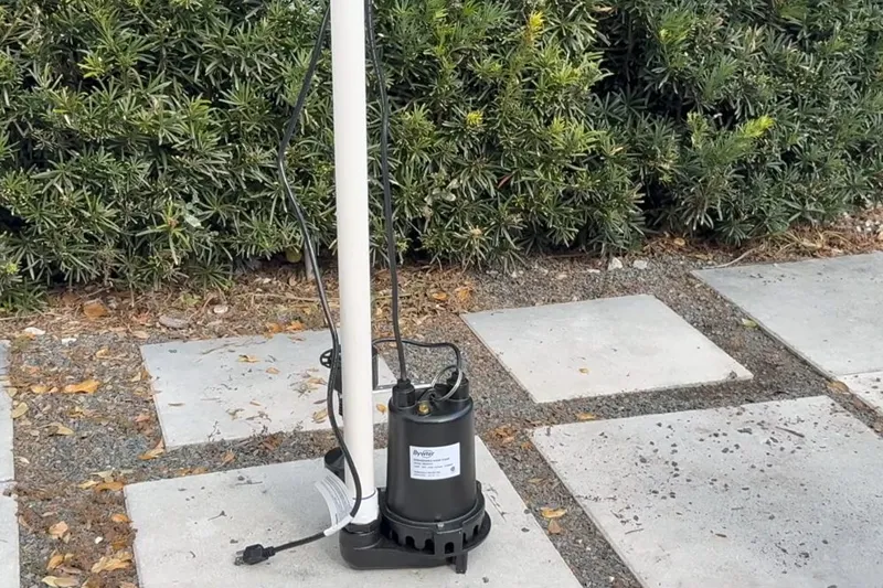 Sump pump and discharge pipe installed in a utility area for A Pronghorn Ranch home in Pronghorn Ranch, Prescott Valley, AZ